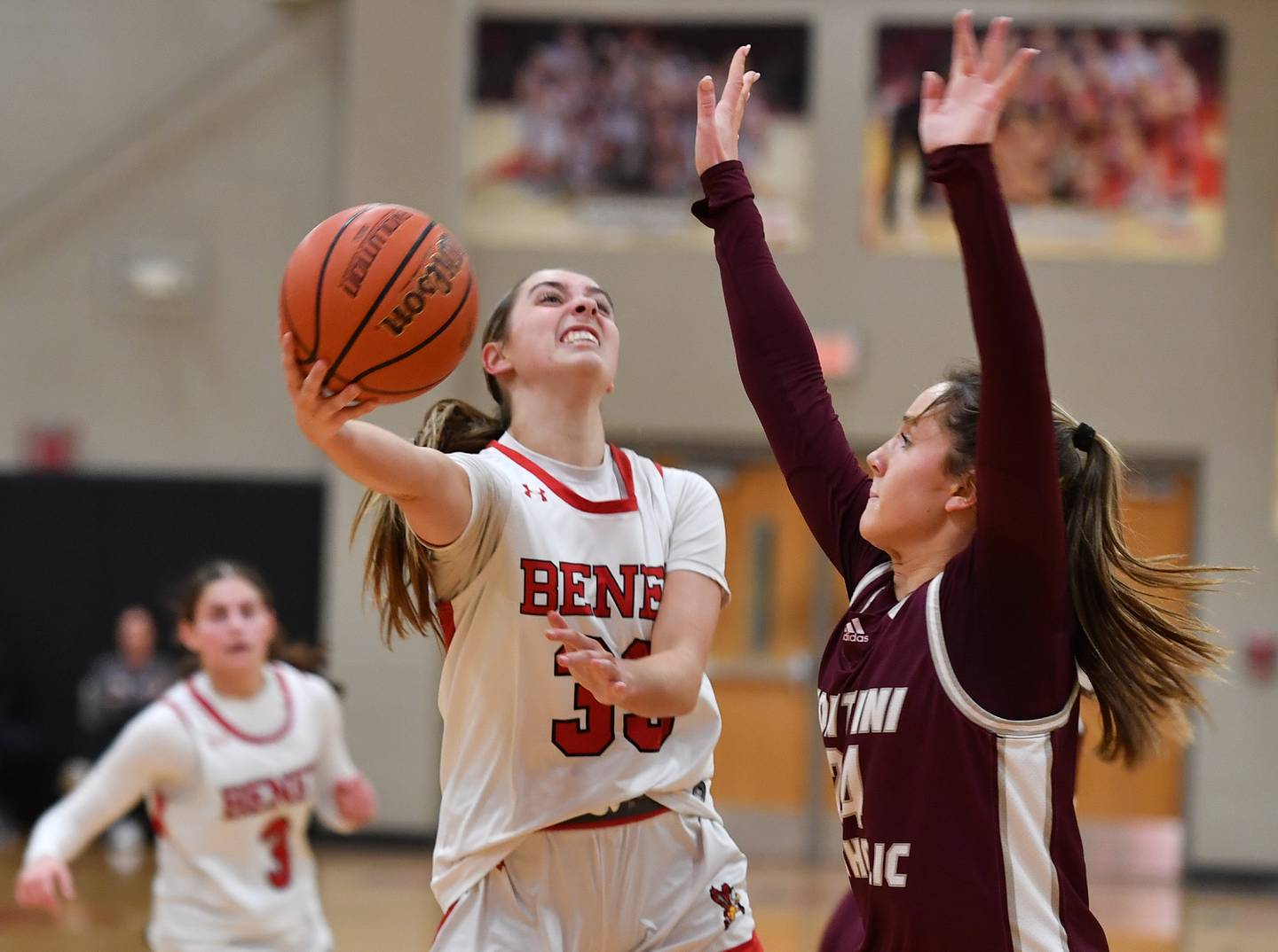 Benet's Magdalena Sularski lays the ball up as Montini's Peyton Farrell (right) defends during a game on Feb. 5, 2024 at Benet Academy in Lisle.