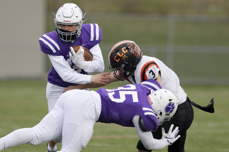 Hampshire's Alexander Corbett runs the ball with blocking help from Raymond Hill, front, on Crystal Lake Central's Colton Madura, right, during their football game on Friday, April 23, 2021 at Hampshire High School in Hampshire.