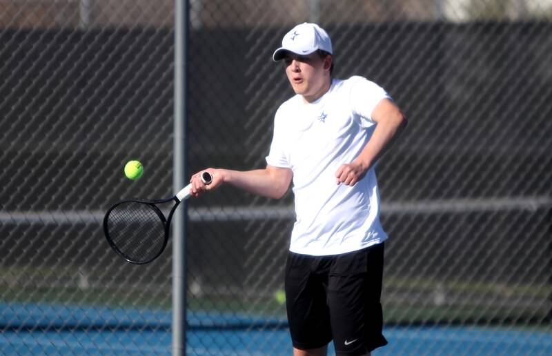 St. Charles North’s Noah Bajuk returns the ball during a number one doubles match against Geneva with partner Brady Barnes in St. Charles on Thursday, April 21, 2022.