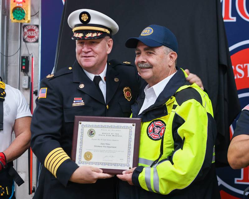 Westmont fire chief Steve Riley presents and posed for a photo with Dave Weiss for Dave’s 50 years of service with the Westmont fire department during the Westmont 100 year anniversary celebration held on Saturday Oct. 14, 2023.