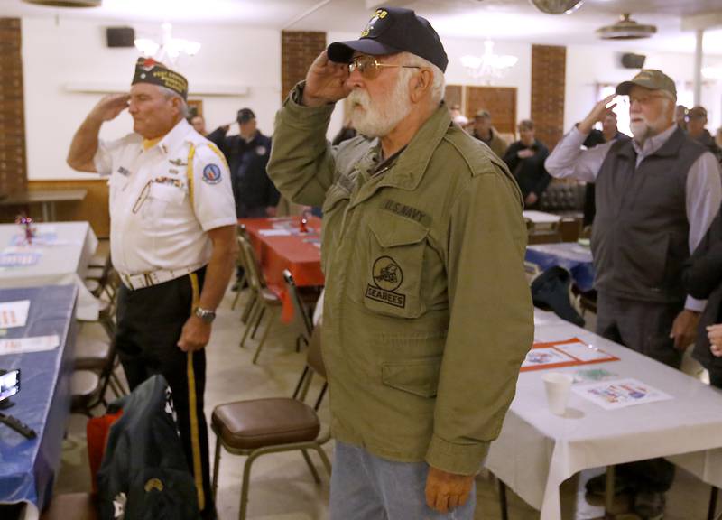 U.S. Navy veteran Dana Woodall, who served during the Vietnam War, salutes the flag while the Pledge of Allegiance is recited during a Veterans Day ceremony Friday Nov. 11, 2022, at the Woodstock Veterans of Foreign Wars Post 5040, 240 N. Throop St. The ceremony featured speeches by Woodstock Mayor Michael Turner and Post Cmdr. Fred Strauss, taps, a 21-gun salute and a luncheon.