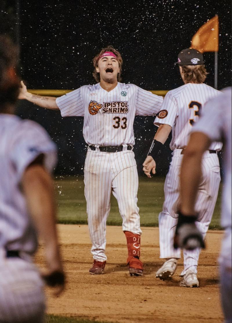 Pambos Nicoloudes (33) celebrates after hitting a RBI single in the bottom of the ninth inning that gave the Illinois Valley Pistol Shrimp a 4-3 win over the Thrillville Thrillbillies on Monday, July 1, 2024 at Schweickert Stadium in Peru.