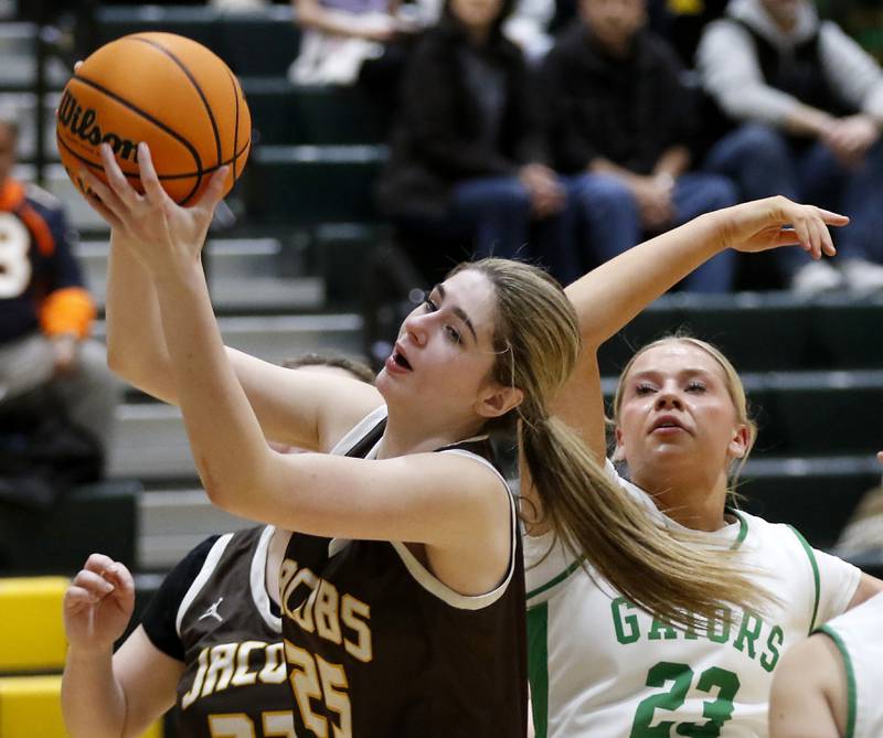 Jacobs' Olivia Schuster grabs a rebound in from to Crystal Lake South's Laken Lepage during a Fox Valley Conference basketball game on Friday, Jan. 17, 2025, at Crystal Lake South High School.