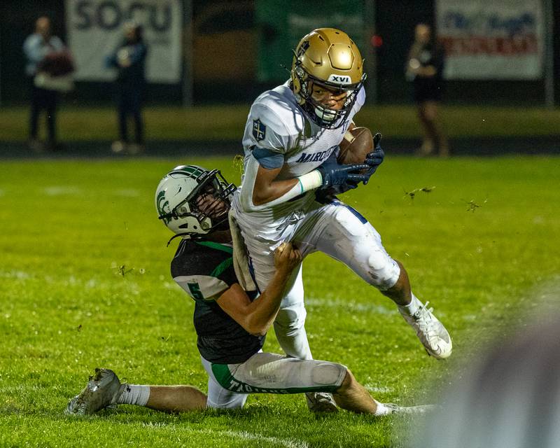 Conner Baker (6) of Marquette runs ball as Joe Duffy (5) of Dwight tackles him on Friday, Sept. 19, 2025 at Dwight High School in Dwight.