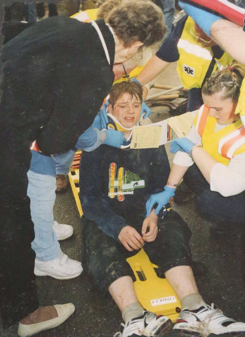 Waltham Grade School student Jared Stillwell receives emergency medical treatment after being rescued from the collapsed century-old Milestone Tavern on April 20, 2004 in Utica.