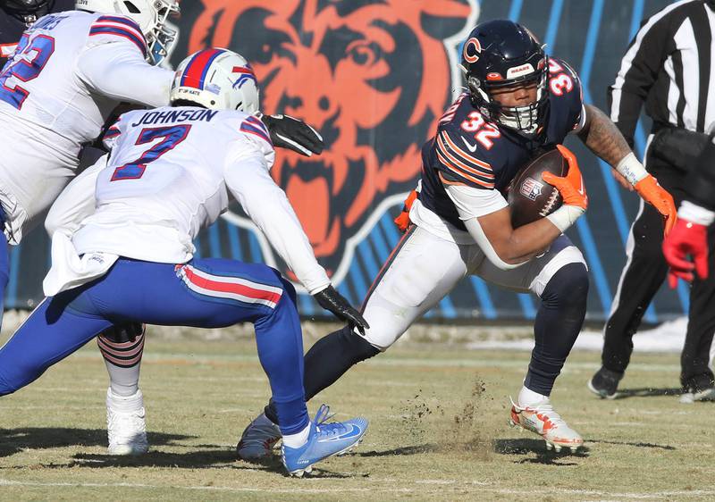 Chicago Bears running back David Montgomery looks to put a move on Buffalo Bills cornerback Taron Johnson during their game Sunday, Dec. 24, 2022, at Soldier Field in Chicago.