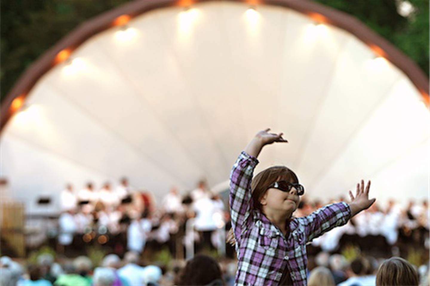 DeKalb resident Zarina Grych, 10, dances Tuesday to a music selection from the "Wizard of Oz" as the DeKalb Municipal Band plays for the first time this year at Hopkins Park in DeKalb.