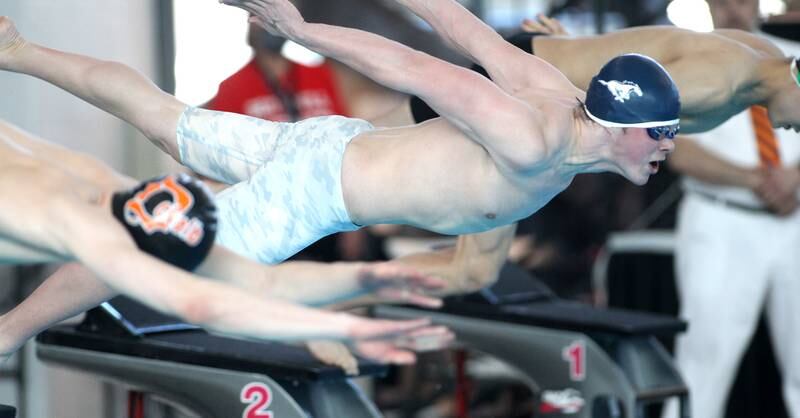 Downers Grove South’s Bobby Sayre goes off the blocks in the consolation heat of the 50-yard individual freestyle during the IHSA Boys Swimming and Diving Championships at FMC Natatorium in Westmont on Saturday, Feb. 26. 2022.