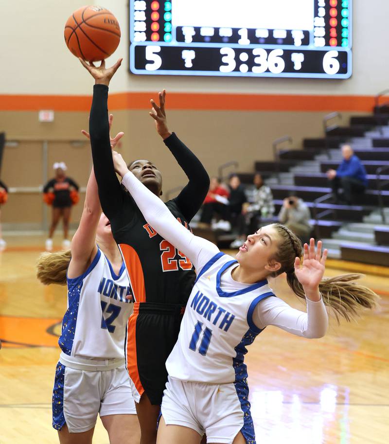 DeKalb’s Kezaria Mitchell is fouled by Wheaton North's Adeline Sutton during their Class 4A regional game Monday, Feb 12, 2024, at DeKalb High School.