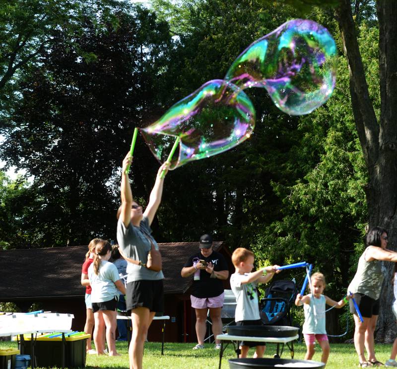 Kirsten Osterloo, a Forreston native, creates a giant bubble at German Valley Days on Saturday, July 19, 2025.