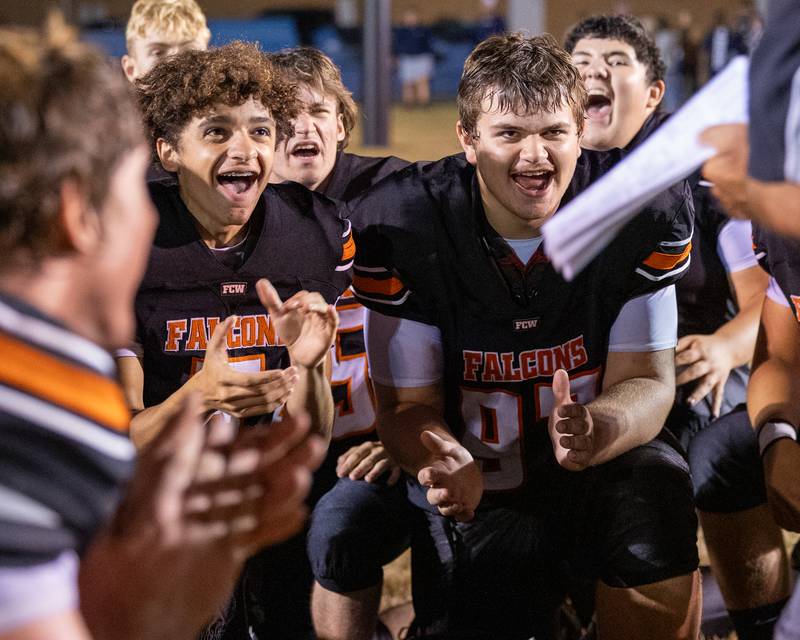 Eli Kapraun (3) of FCW and teammate Doug Smith (97) celebrate in post-game huddle on Friday, Sept. 26, 2025 at Woodland High School in Streator.