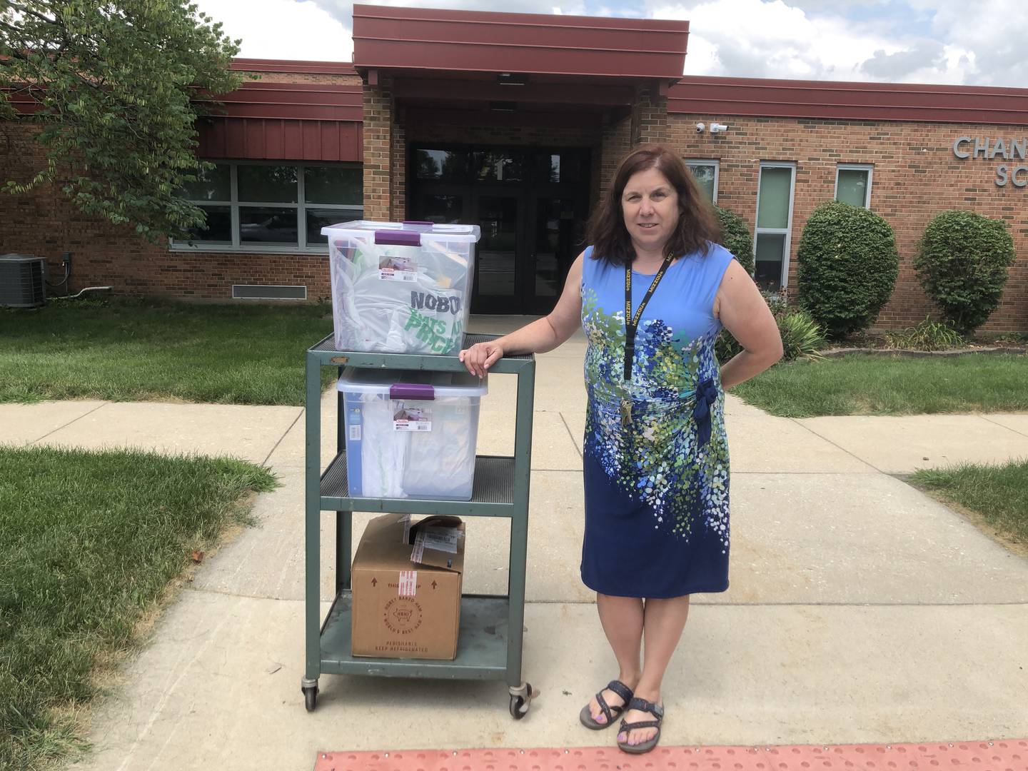 Jackie Hall, principal at Chaney-Monge School District 88 in Crest Hill, receives some of the school supplies that the singles club at Carillon Lakes in Crest Hill collected.