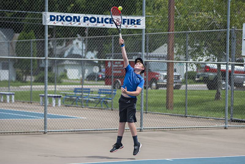 Joel Rhodes serves to his opponent while playing in the 15 and under boys single tournament during the Emma Hubbs tennis classic in Dixon.