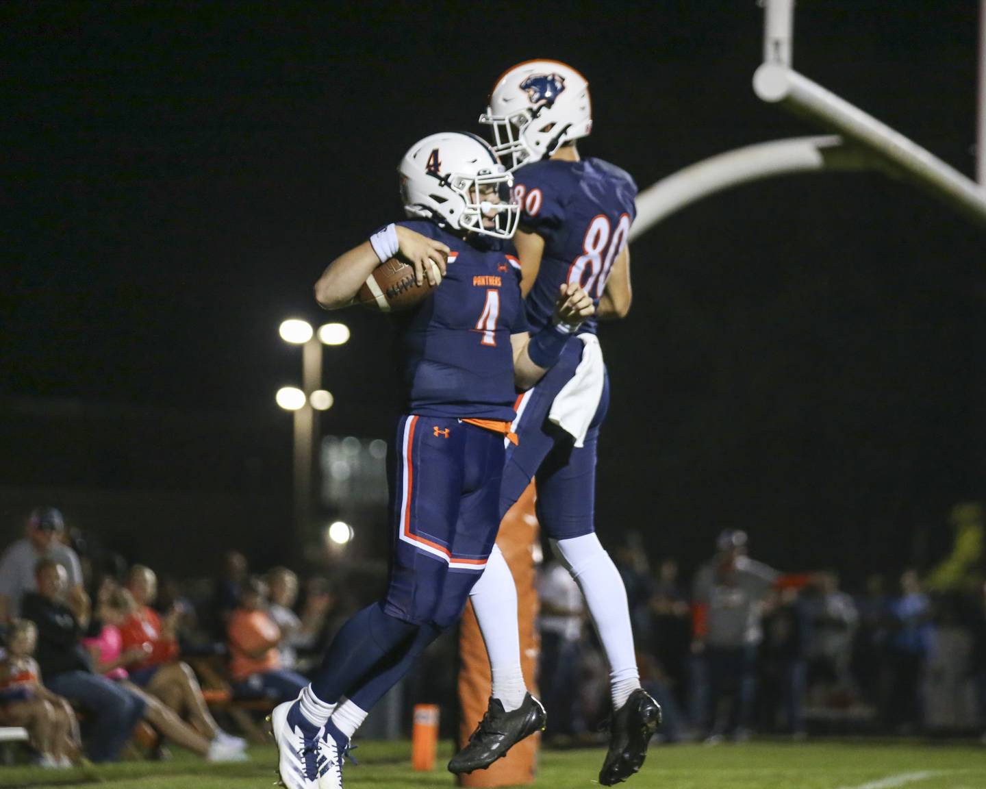 Oswego's Drew Kleinhans (4) celebrates a touchdown with  Caleb Miller (80) during football game between Bolingbrook at Oswego Friday, Sept 12, 2025  in Oswego.