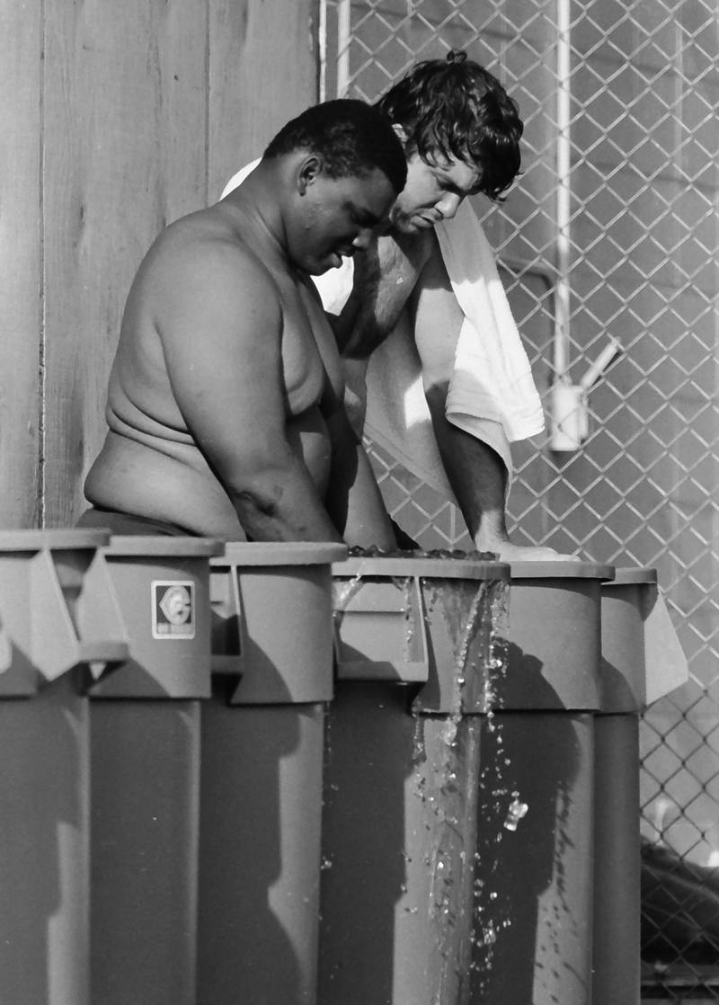 Chicago Bears lineman William Perry cools off in an ice bucket during training camp on Wednesday, June 12, 1985 in Platteville Wis.