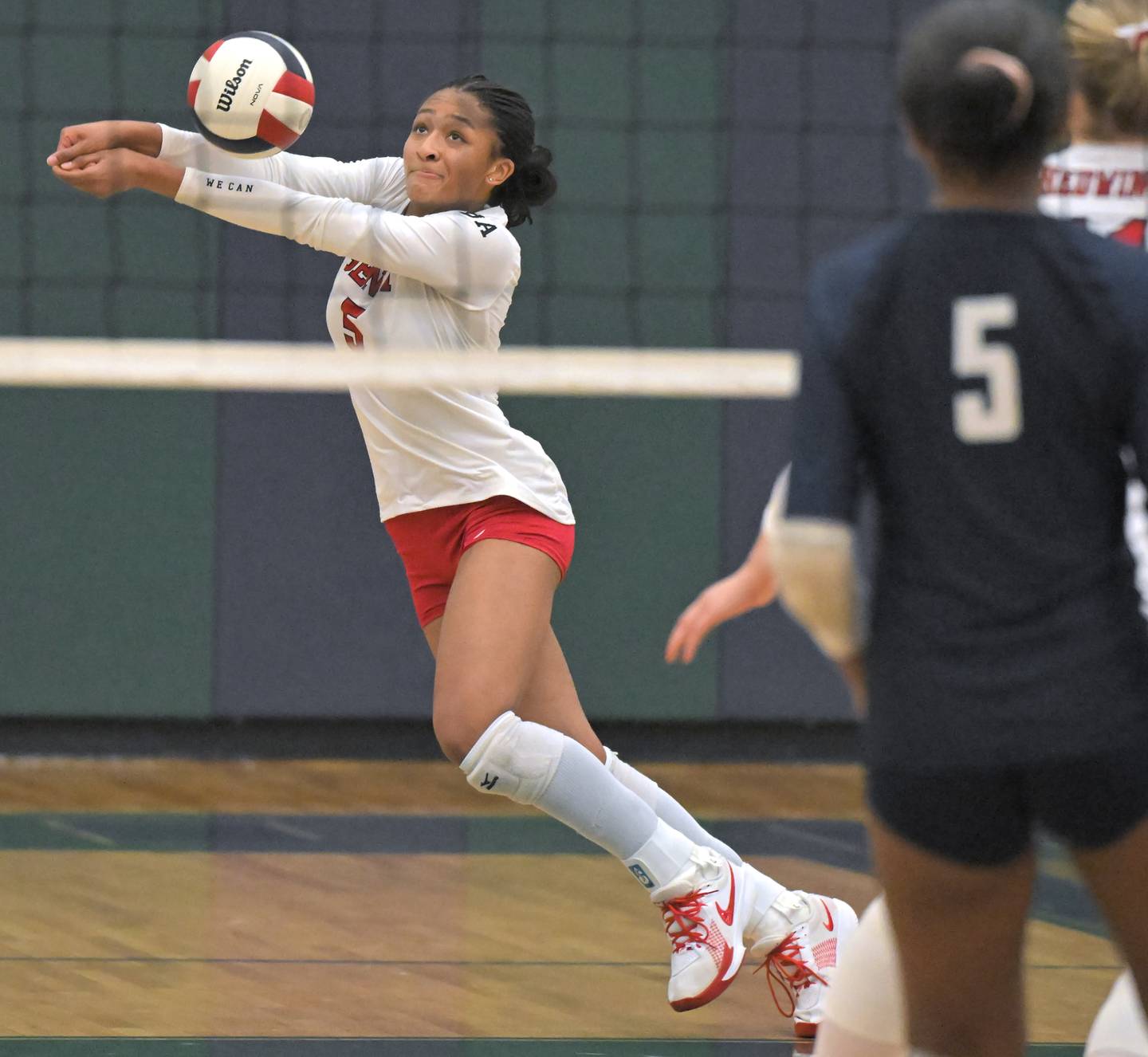 Benet’s Brooklynne Brass chases a New Trier shot in a supersectional girls volleyball match Monday, Nov. 10, 2025 in Bartlett.