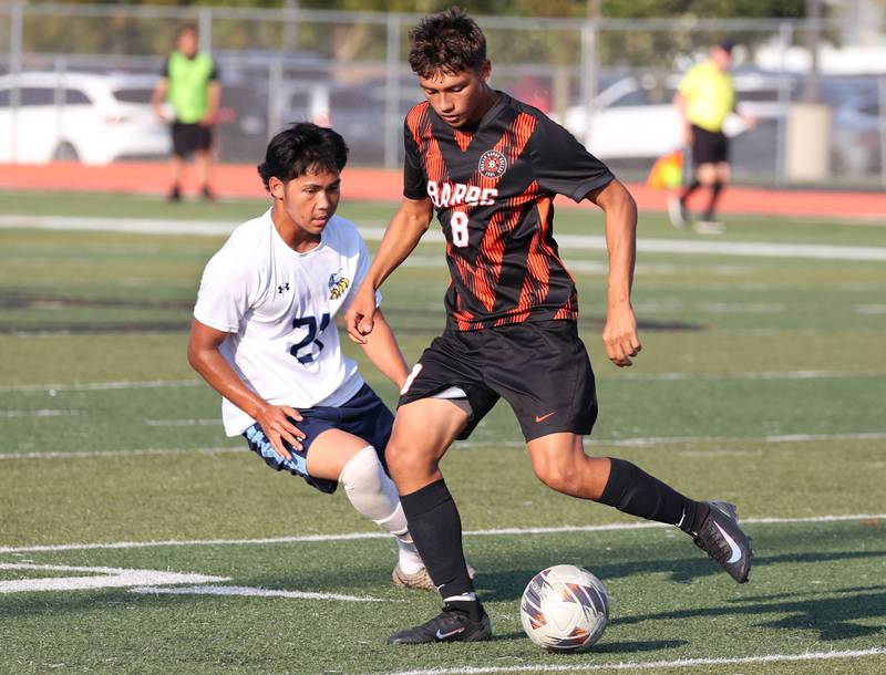 DeKalb's Brandon Garcia tries to get by Guilford's Hsa Pler during their game Thursday, Sept. 18, 2025, at Dekalb High School.