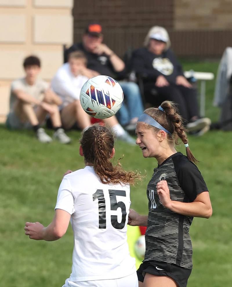 Sycamore's Faith Schroeder heads the ball away from Prairie Ridge's Olivia McPherson during their game Wednesday, May 17, 2023, at Sycamore High School.