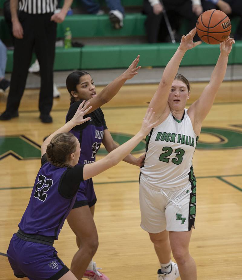 Rock Falls’ Claire Bickett makes a pass while being guarded by Dixon’s Katie Drew (left) and Ahmyrie McGowan Wednesday, Jan. 31, 2024 at Rock Falls High School.
