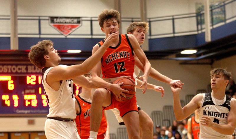 McHenry’s Caleb Jett gathers a rebound against Kaneland in Hoops for Healing basketball tournament championship game action at Woodstock Wednesday.