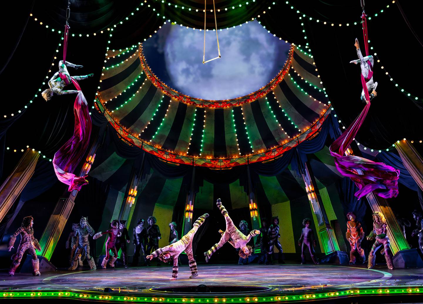 Talented acrobats and daring aeralists are all part of Paramount Theatre’s circus-inspired production of Cats. Cartwheeling on stage are Dani Goldberg, left, as Rumpleteazer, and Michael Lunder as Mungojerrie. Flying through the air with the greatest of ease, above, are Kat Harvey, left, as Tantomile and Ryan Huemmer as Coricopat. Performances run through June 15, 2025. For tickets, visit ParamountAurora.com or call (630) 896-6666. 2025