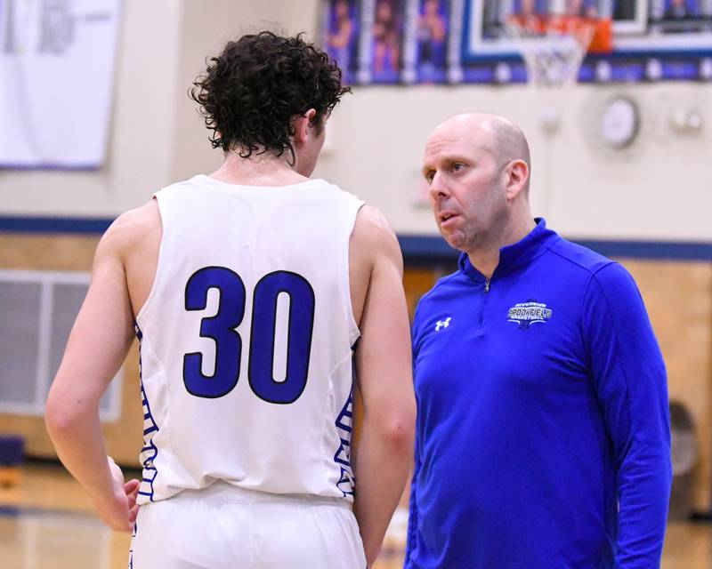 Riverside-Brookfield’s head coach Michael Reingruber talks with Liam Enright (30) during a break in the game on Tuesday Feb. 3, 2026, while taking on Glenbard East held at Riverside-Brookfield High School.