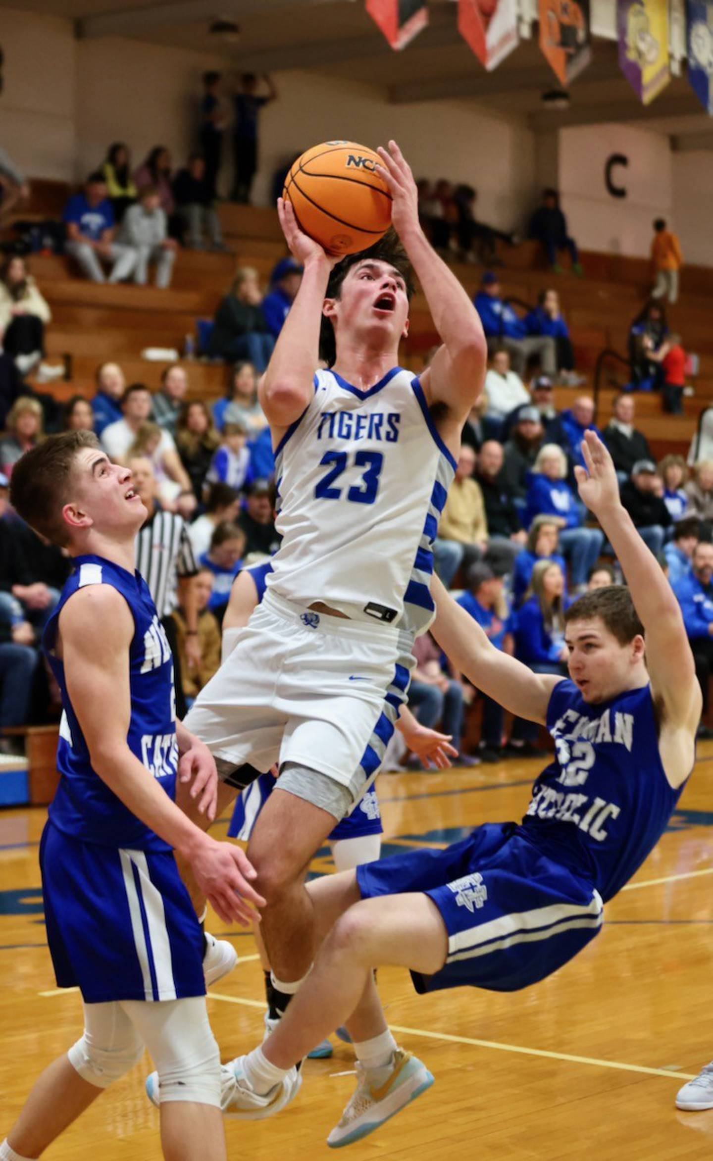 Princeton senior Noah LaPorte splits the Newman defense for a basketball Friday night at Prouty Gym. The Tigers won 60-46.