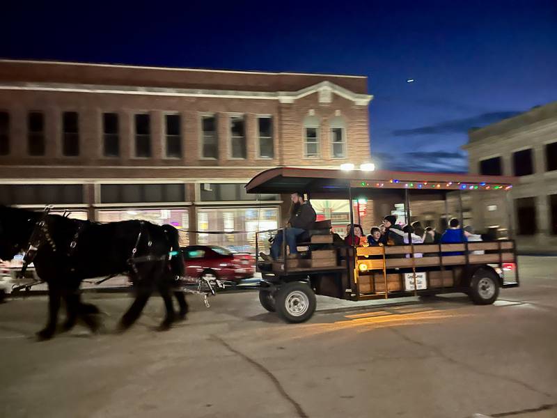 A Cargill horse and wagon ride turns east onto East Mason Street in Polo on Saturday, Dec. 7, 2024. The horse-drawn rides were yet another activity available at the sixth annual Polo Christmas Festival.