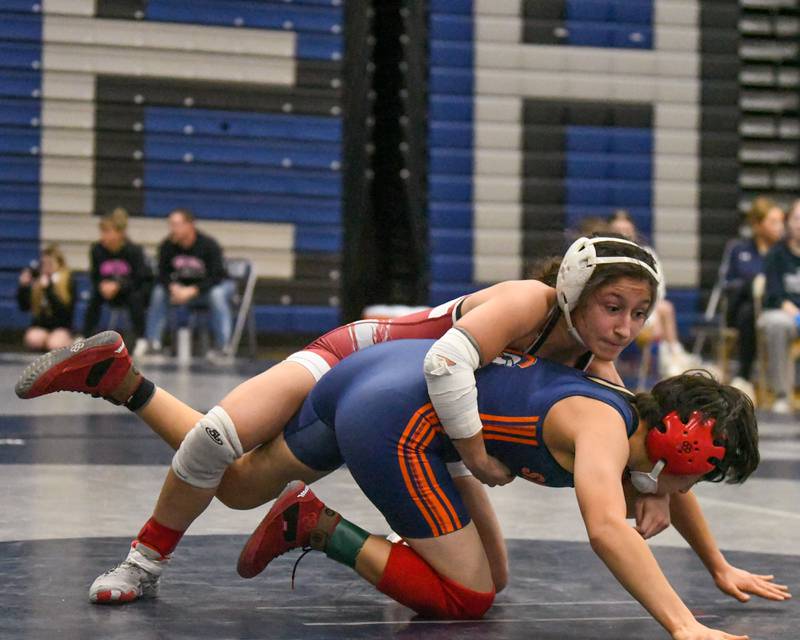 Averia Colella, top, of Lockport wrestles Daniela Santander of Romeoville during the 105-weight class on Saturday Jan. 4, 2025, in the championship match up where Averi won in a 9-1 decision during the Aaron Dundley invite held at Oswego East High School.