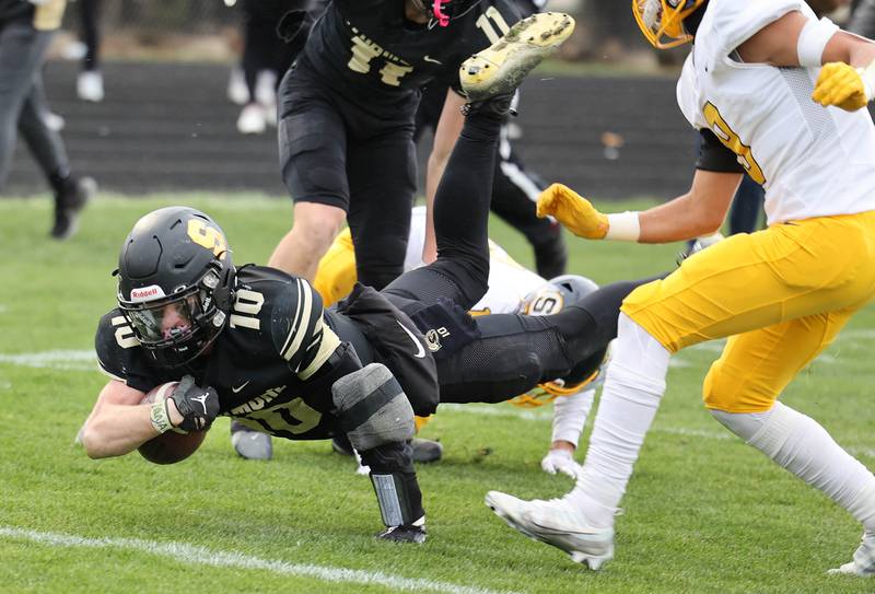 Sycamore's Zack Crawford dives for the end zone in front of Sterling's AJ Kested during their Class 5A state playoff game Saturday, Nov. 12, 2022, at Sycamore High School.