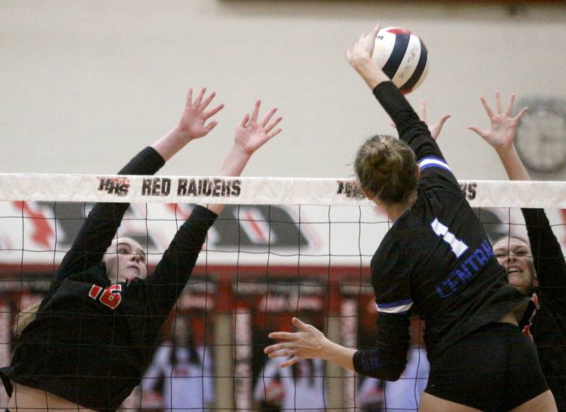 Huntley’s Georgia Watson, left, and Summer Massow, right, block Burlington Central’s Peyton Stout in varsity volleyball at Huntley High School in Huntley on Thursday, Oct. 24, 2024.
