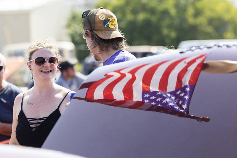 The mirror-like shine of Lonny Peach’s ’66 Chevy reflects a flag Sunday, Aug. 25, 2024, in Amboy.