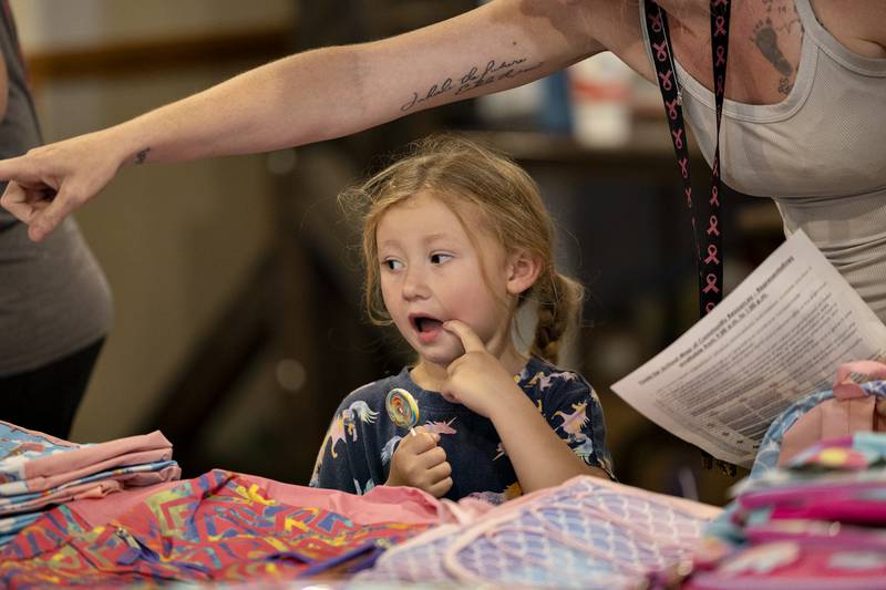 Oceanna Olroyd helps daughter Avianna Medina, 4, pick out a backpack Thursday, August 7, 2025, at Dixon School’s Tools for School giveaway. Parents and students stopped by the Elk’s Club to pick up supplies, grab a hair cut and find other resources for the upcoming school year.