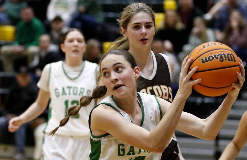 Crystal Lake South's Tessa Melhuish grabs a rebound in front of Jacobs' Olivia Schuster during a Fox Valley Conference basketball game on Friday, Jan. 17, 2025, at Crystal Lake South High School.