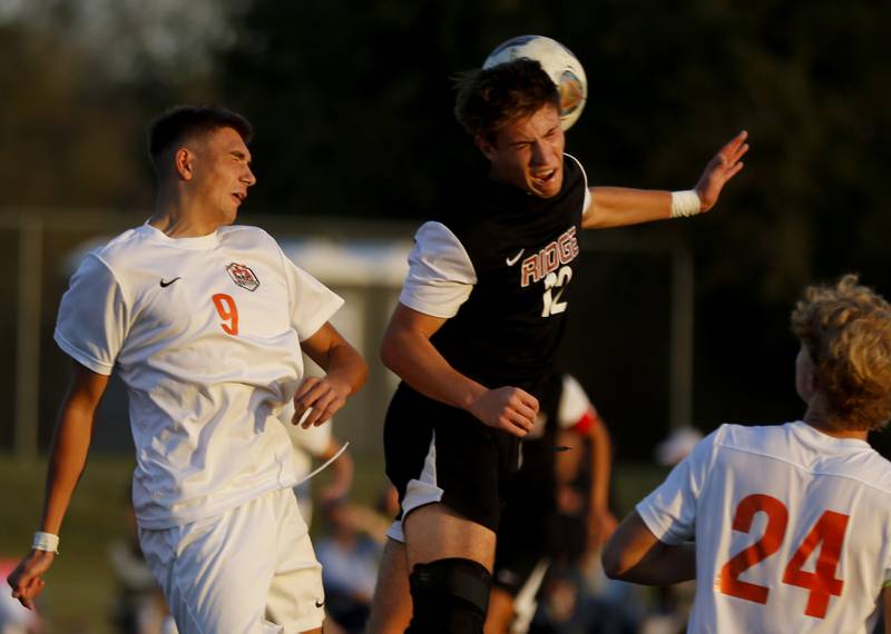 Crystal Lake Central's Mattia Zavattaro heads the ball away from Prairie Ridge's Samuel Kirk during a Fox Valley Conference soccer match on Thursday, Oct. 10, 2024, at Prairie Ridge High School.