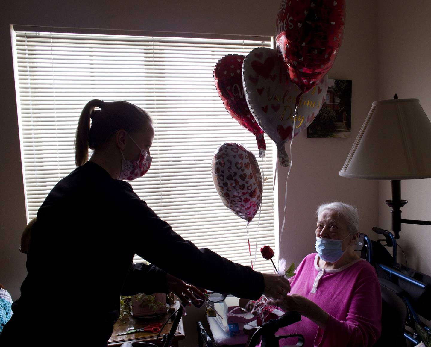 Kara Rauhut Timbers CNA passes out a special Valentine’s Day surprise to resident Rita Zobran. Families of residents, Timbers’ neighbors and local businesses purchased packages for residents. The package included a chocolate rose, a heart-shaped balloon, and a personalized card. The $1600 raised from the event was donated to the Alzheimer’s Association.