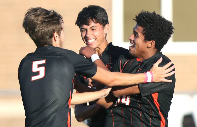 DeKalb's Tyler Diedrich, (left) Kendall Gilkey and Josiah Antimo (right) celebrate Antimo's second goal of their game against Sycamore Tuesday, Oct. 4, 2022, at DeKalb High School.