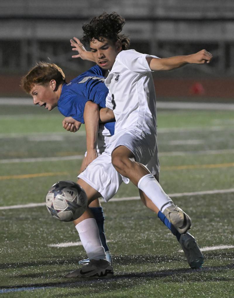 West Chicago’s Enrique Correa blocks St. Charles North’s Nolan Schoenholz as he moves the ball upfield in a boys soccer game in St. Charles on Wednesday, Sept. 4, 2024.