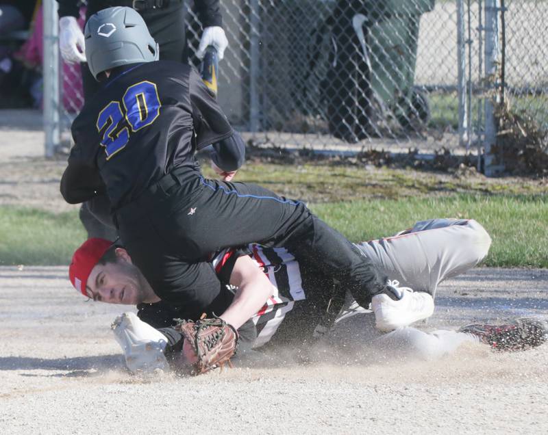 Sononauk's Noah Brandt (20) collides with Earlville's Bryar Keller (5) at home plate on Thursday, April 14, 2022, in Somonauk.