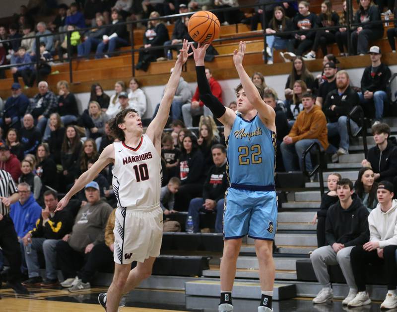 Marquette's Griffin Dobberstein shoots a jump shot over Woodland's Jaron Follmer during the Tri-County Conference Tournament championship on Friday, Jan. 30, 2026 at Putnam County High School.