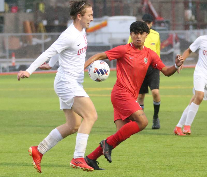 Ottawa's Alexzander Houk knocks the ball down as L-P's Brayan Gonzalez defends on Monday, Sept. 11, 2023 at the L-P Athletic Complex in La Salle.