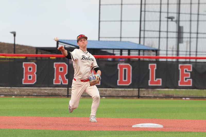 Bradley-Bourbonnais' Jace Boudreau throws to first base for an out during the Boilermakers' 8-7 loss to Homewood-Flossmoor on Monday, April 13, 2026.
