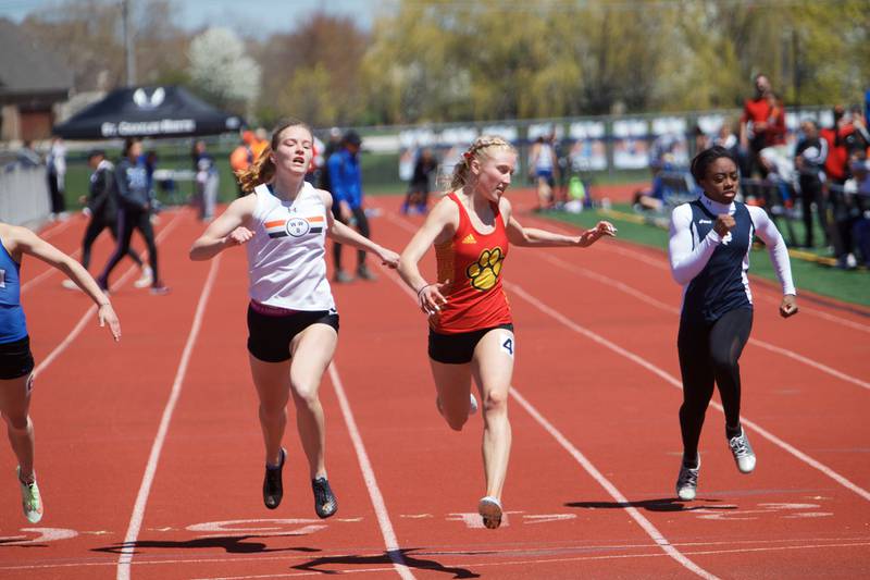 Wheaton Warrenville South's Grace Macabobby, Batavia's Jessica Newburn, and Lake Park's Imani Ogunribido head for the finish line in the 100 Meter Dash at the DuKane Girl's Conference meet at St. Charles North on May 7, 2022 in St. Charles.