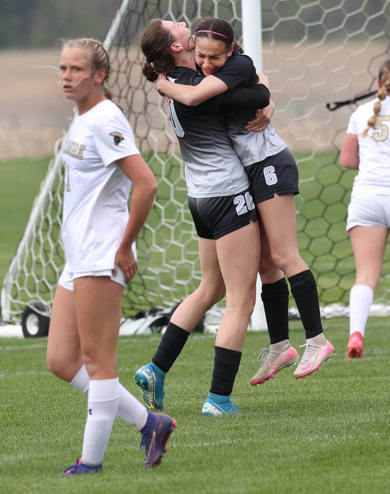 Kaneland's Taylor Mills (right) celebrates after she scored a goal against Sycamore with teammate Erin Doucette Wednesday, April 30, 2025, during their game at Kaneland High School in Maple Park.