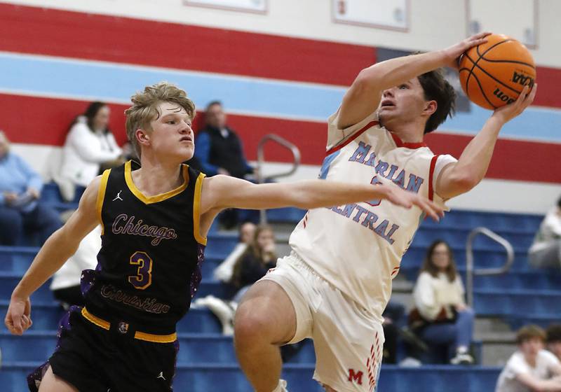 Marian Central's Logan Brandt drives to the basket against Chicago Christian's Garrett Murphy during a Chicagoland Christian Conference basketball game on Tuesday, Jan. 21, 2025, at Marian Central High School.