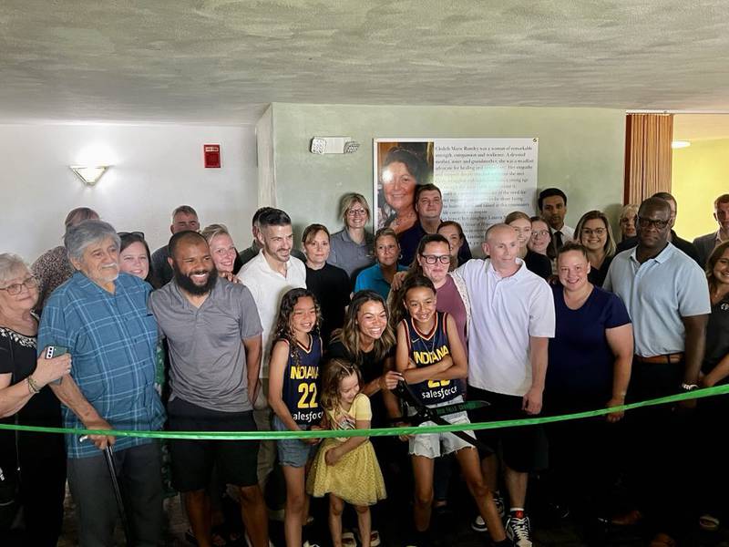 Sauk Valley Voices of Recovery Operations Manager Lauren Metzler cuts the ribbon at the new women's sober living facility, Cledy's House of Hope, in Rock Falls on Tuesday, May 13, 2025.