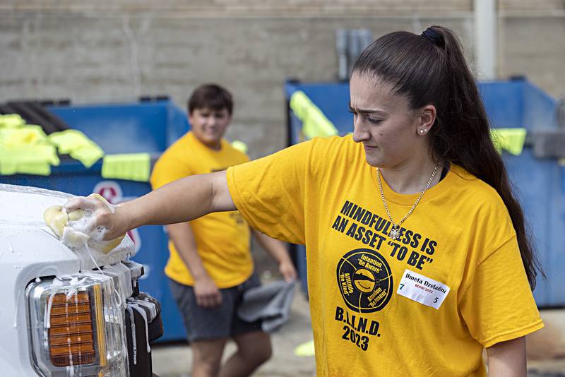 Morrison BLIND leader Ilmeta Dzeladini gets to work washing a truck Friday, August 4, 2023. The leaders, chosen by staff, leaders and peers at their respective high schools, will be undergoing training this weekend.