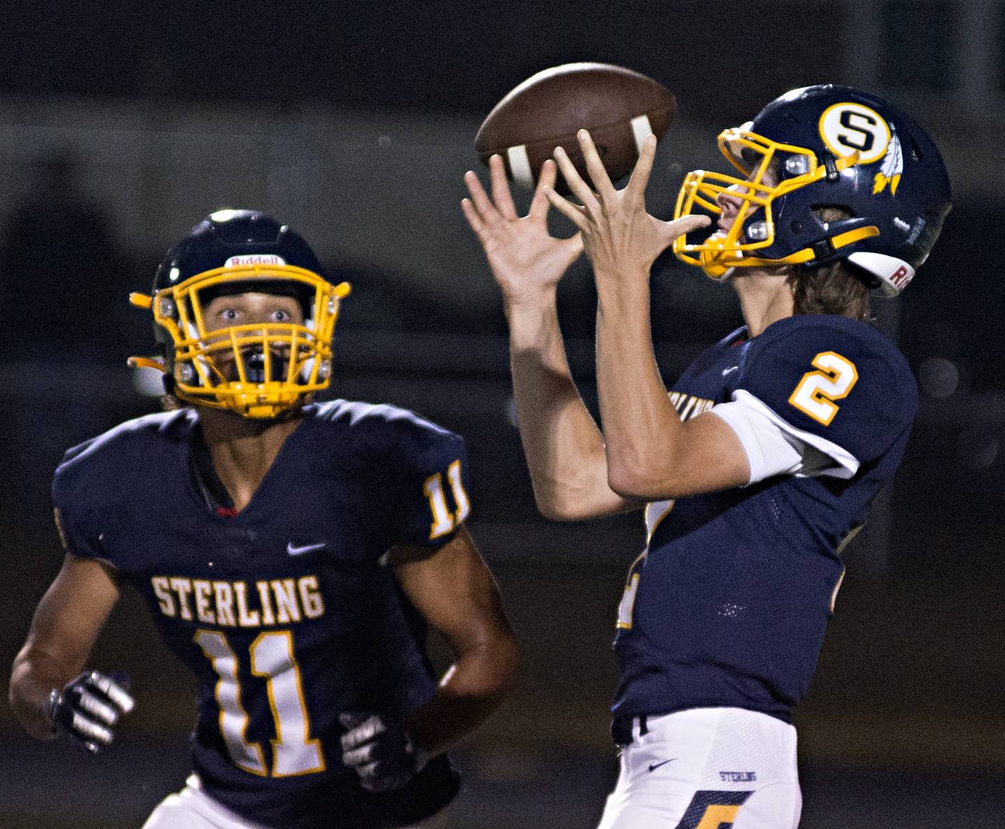 Sterling's Garrett Polson fumbles the snap Friday while looking to hand off to Tyree Kelly.