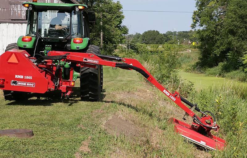 Curt Spayer, Utica public works superintendent, uses a special boom mower that can extend up to 18 feet to eliminate weeds and brush along the Illinois and Michigan Canal in Utica. The village has improved the canal’s overall appearance and wants to refill it.