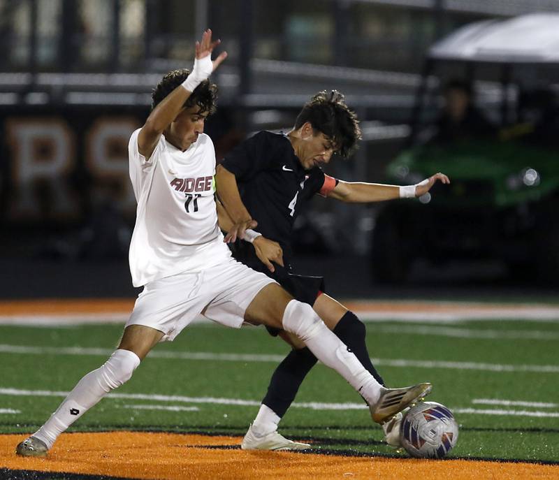 Prairie Ridge's Anthony Castro tries to get the ball away from McHenry's Cole Tapia uring a Fox Valley Conference boys soccer match on Tuesday, Sept. 30, 2025, at McCracken Field in McHenry.
